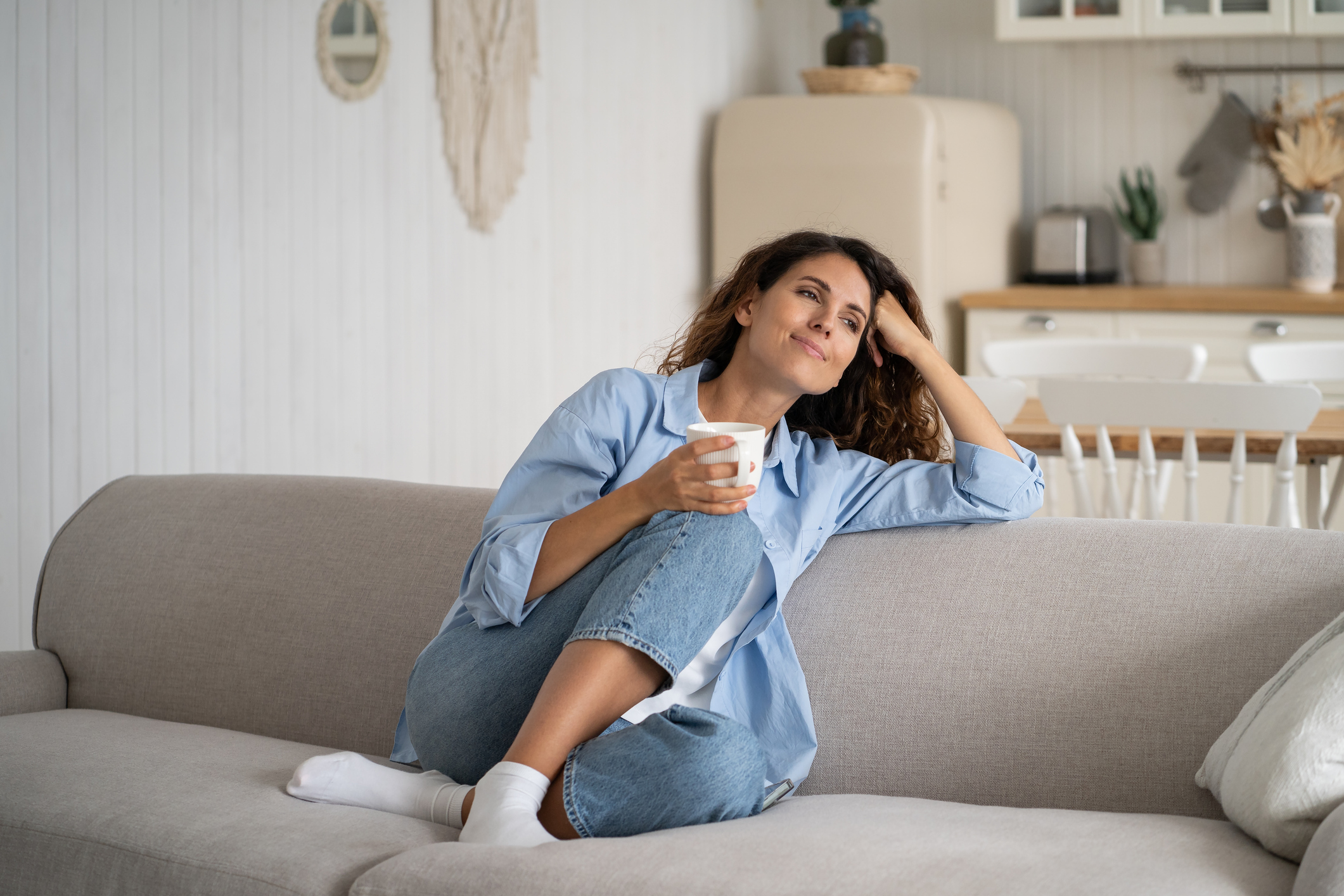 Person relaxing with coffee in a clean home